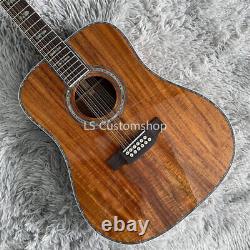 Guitare électro-acoustique 12 cordes sur mesure en Koa intégral avec incrustations en abalone.